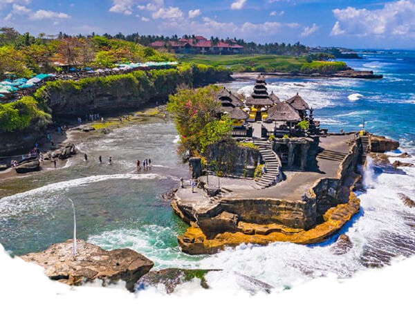 Witness the mesmerizing sunset at Tanah Lot Temple, perched on a rocky outcrop by the sea.